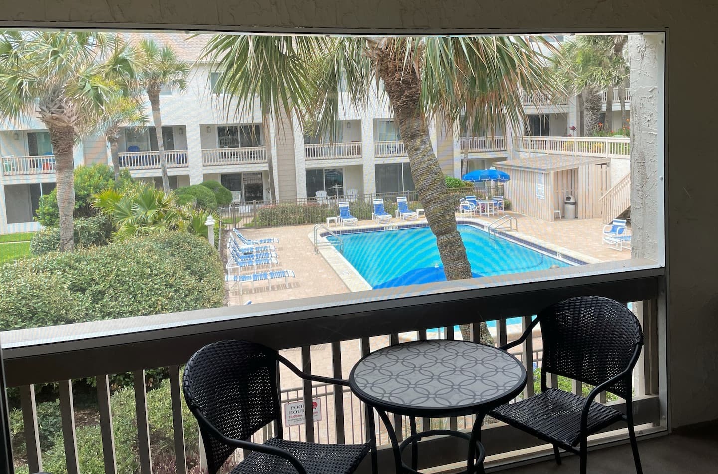 screened balcony overlooking pool.jpeg