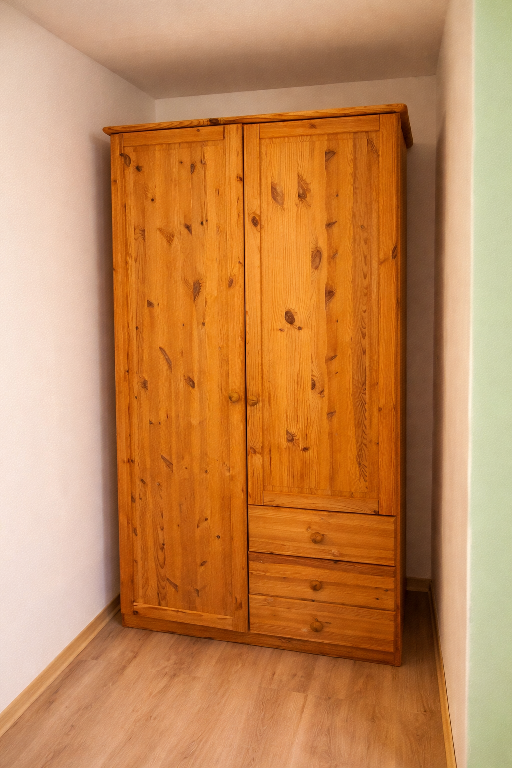 Rustic pine wardrobe in bright room.png